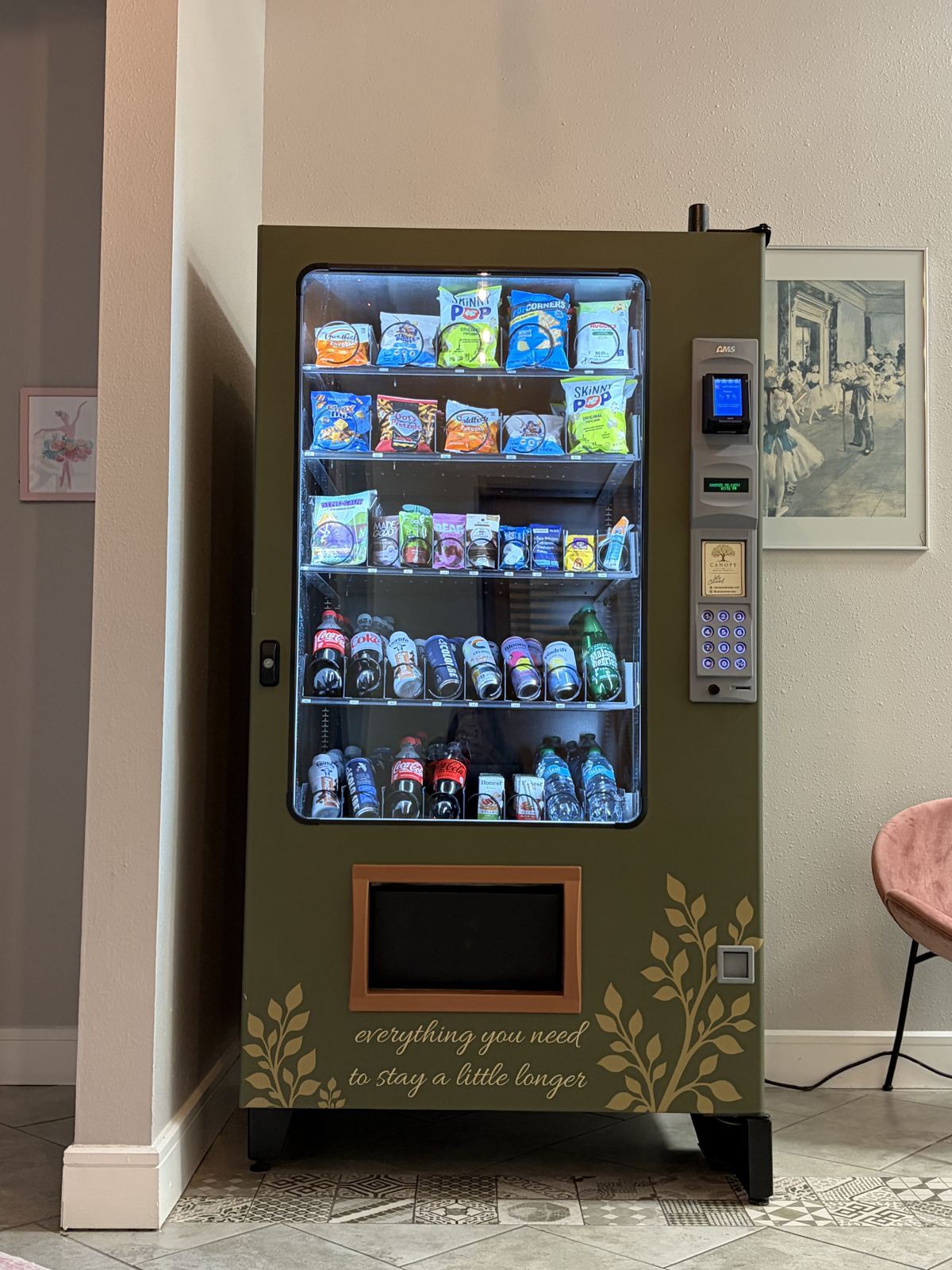 The front of a stocked Canopy machine, printed with 'everything you need to stay a little longer'