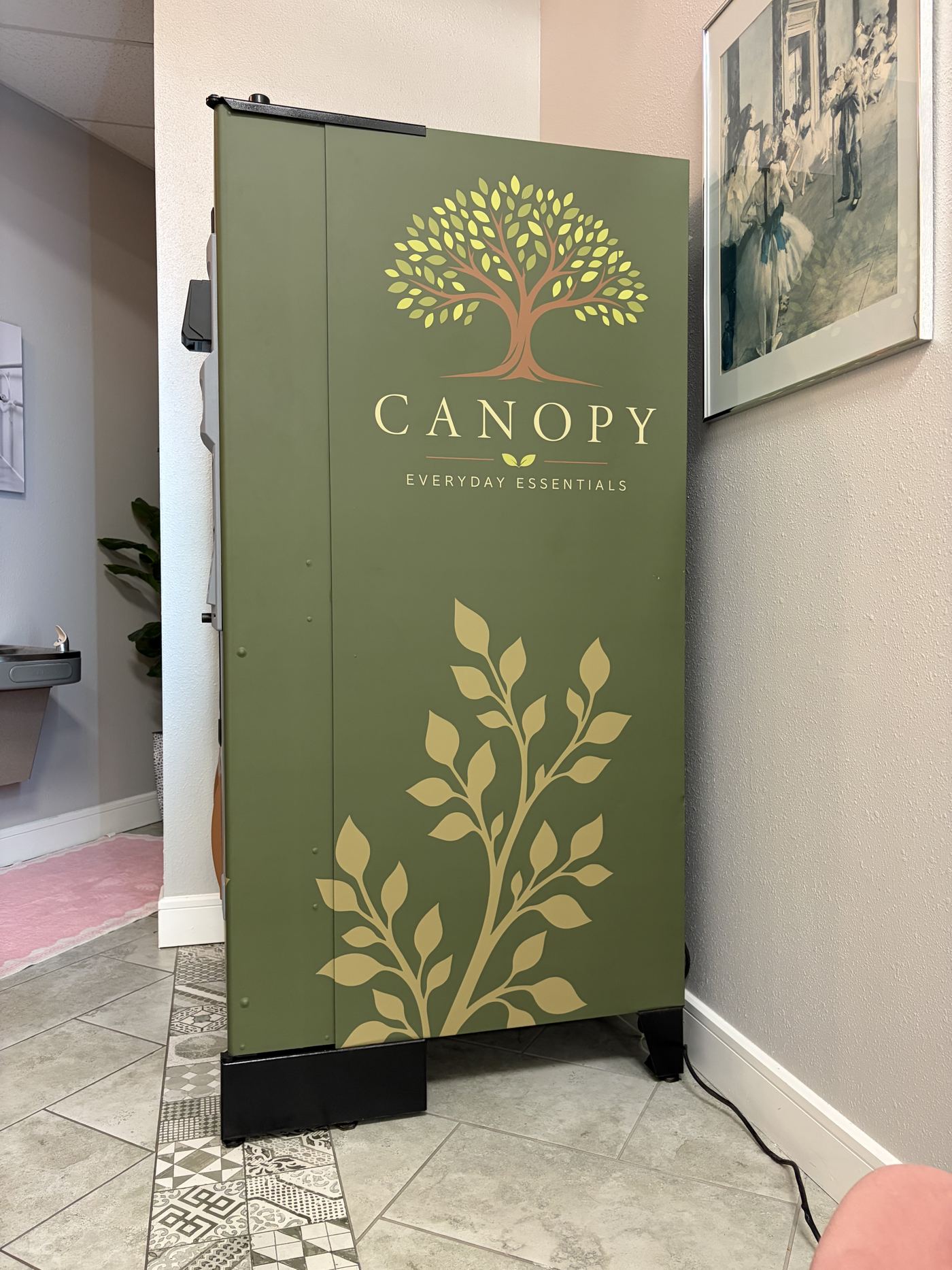 The side of the Canopy machine: the Canopy tree logo above a gold vine